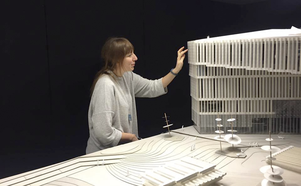 Katie Paterson looking at a smal scale model of Deichman Bjørvika